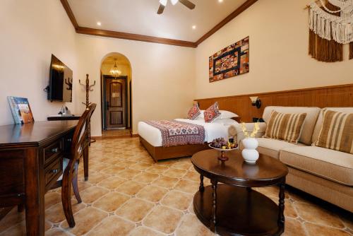 a hotel room with a bed and a couch at Karamay West Wuzhen Tancheng Hotel in Urho