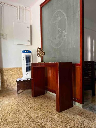 a room with a table and a large screen at Puthukkeril Heritage Home in Talavadi