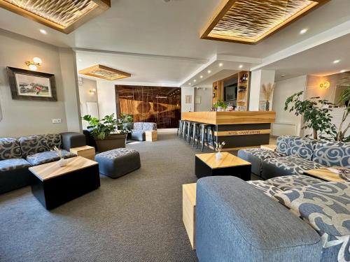 a large living room with couches and a piano at Hotel Chantereyne in Cherbourg en Cotentin
