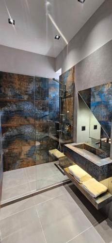 ein Badezimmer mit Glasdusche und Waschbecken in der Unterkunft Old Avenue Hotel in Gjumri