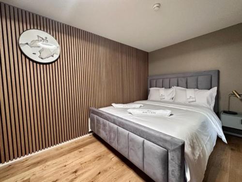 a bedroom with a large bed with a clock on the wall at BERG & BERG HOTEL - Kerns Self-Check-in in Kerns