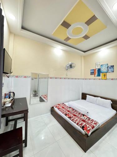 a bedroom with a bed and a desk and a ceiling at NHÀ NGHỈ THANH XUÂN- Có cho thuê xe máy và xuất hóa đơn in Ấp Ðông An (1)