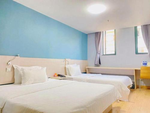 Ένα ή περισσότερα κρεβάτια σε δωμάτιο στο 7 Days Inn Nanjing Jiangning University Town