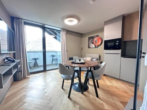 a kitchen and dining room with a table and chairs at BERG & BERG HOTEL - Kerns Self-Check-in in Kerns