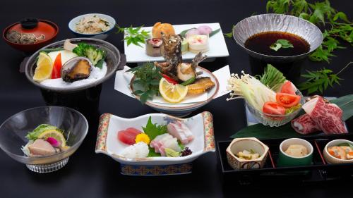 a group of plates of food on a table at Tenku Hotel Kairo in Tonosho