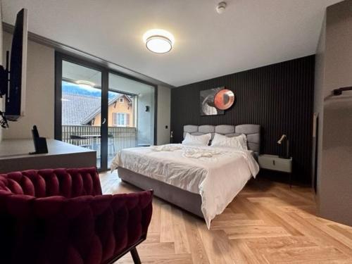 a bedroom with a large bed and a large window at BERG & BERG HOTEL - Kerns Self-Check-in in Kerns