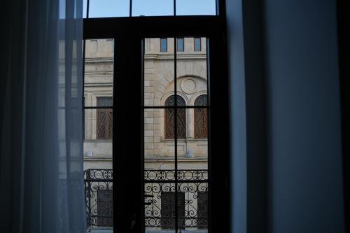 a view of a building through a window at Hotel BABU in Kutaisi