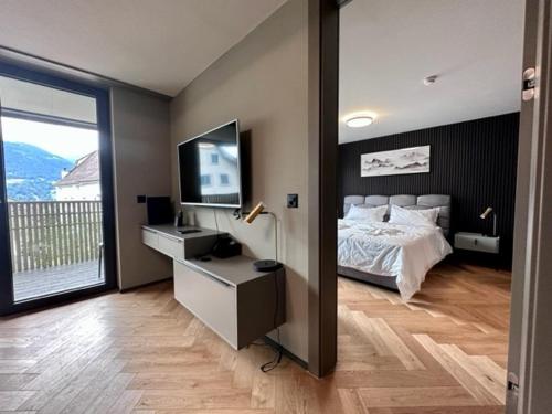 a bedroom with a bed and a flat screen tv at BERG & BERG HOTEL - Kerns Self-Check-in in Kerns