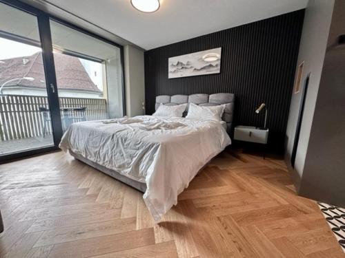 a bedroom with a large bed and a large window at BERG & BERG HOTEL - Kerns Self-Check-in in Kerns