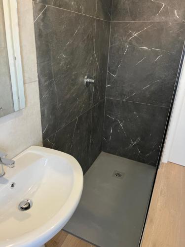 a bathroom with a sink and a shower at BERGAMO AIRPORT ROOMS Self check-in in Bergamo