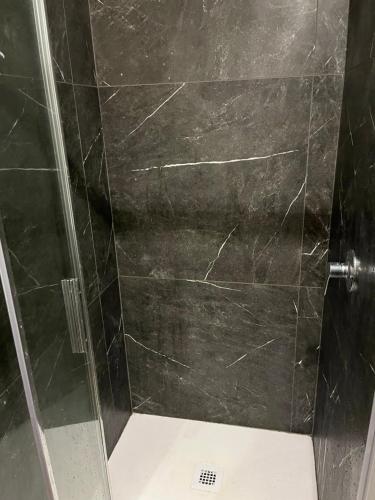 a shower with a glass door in a bathroom at BERGAMO AIRPORT ROOMS Self check-in in Bergamo