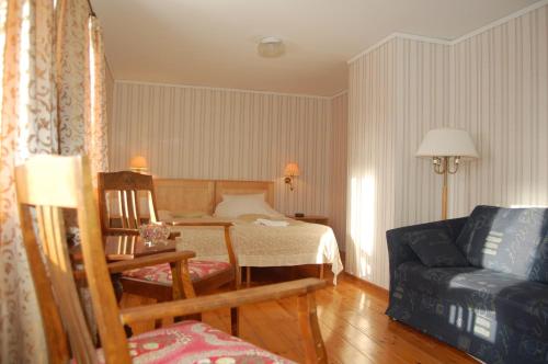 a hotel room with a bed and a couch at STF Vickleby Bo Pensionat in Färjestaden