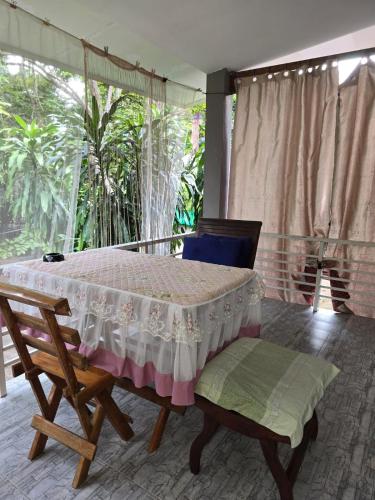 a bedroom with a bed and a large window at Cozy Modern House, Top Spot in Baan Tai