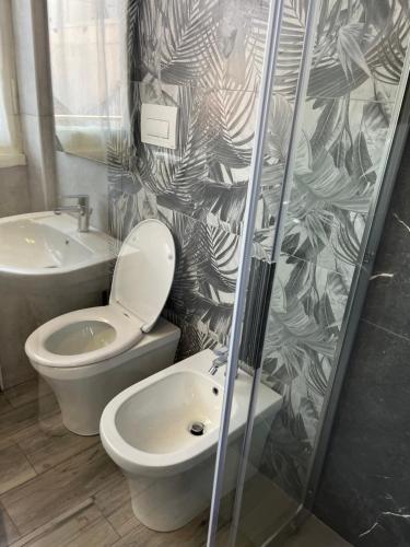 a bathroom with a toilet and a sink at BERGAMO AIRPORT ROOMS Self check-in in Bergamo