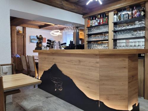 a bar with a wooden counter and a table at Hotel Reitherhof in Reith bei Seefeld