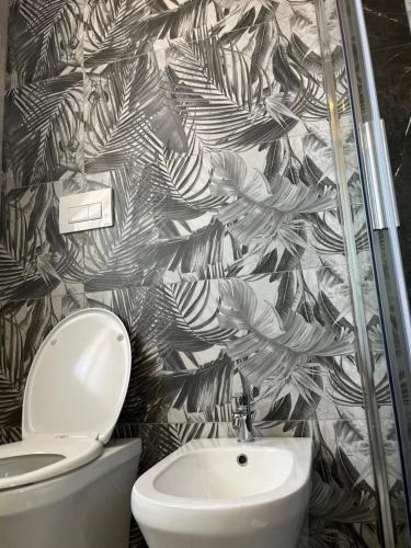 a bathroom with a toilet and a sink at BERGAMO AIRPORT ROOMS Self check-in in Bergamo