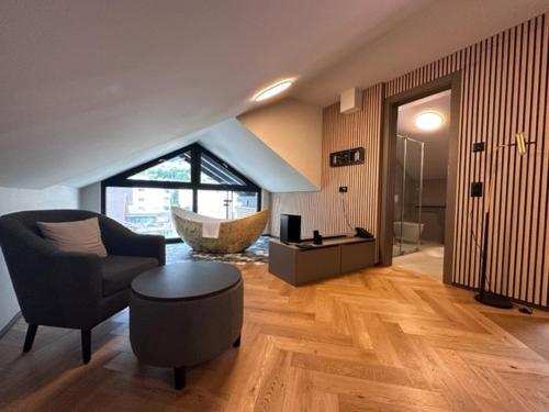 a living room with a couch and a chair and a tub at BERG & BERG HOTEL - Kerns Self-Check-in in Kerns