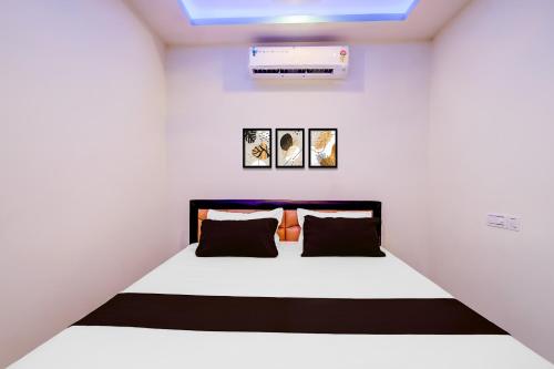 a bedroom with a bed in a white room at Hotel O The Silver Stone in Guwahati