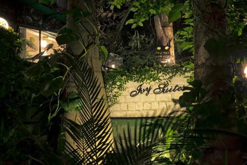 a sign for a snow church in a garden at night at Ivy Suites in Bhopal