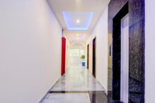 a hallway with white walls and a ceiling at Hotel O The Silver Stone in Guwahati