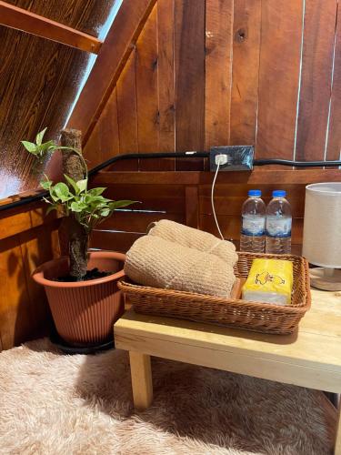 a table with a basket of water bottles on it at Khao Phang Camping in Ban Pha Saeng Lang