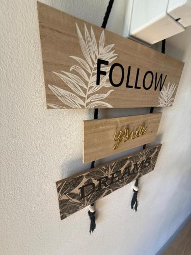 a sign on a wall with the word follow at LivePro in Larnaka