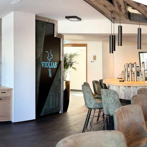 a room with chairs and a table and a sign at Wander- und Familienhotel Erika in Wagrain