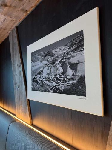 a black and white picture hanging on a wall at Wander- und Familienhotel Erika in Wagrain