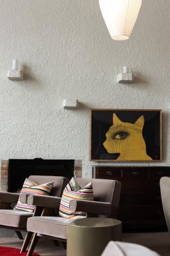 a living room with two chairs and a picture of a cat at Kogakuro in Myoko