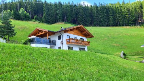 a house on top of a grassy hill at Almliesl WALD-745 in Hinterwaldberg