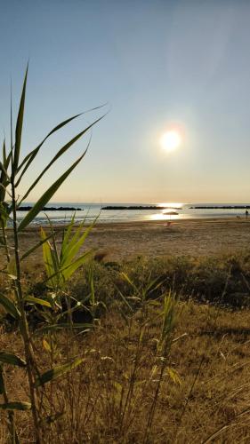 a view of a beach with the sun setting at Sake' Beach in Senigallia