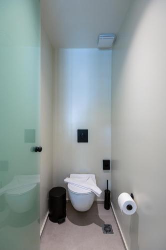 a bathroom with a toilet and a roll of toilet paper at Sunny Days in Tigaki