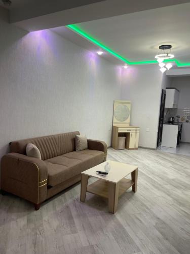 a living room with a couch and a coffee table at Kaspi House in Astara