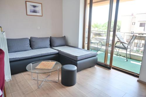 a living room with a couch and a table at Apartments Novak in Rovinj