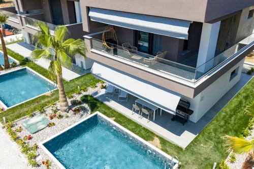 an aerial view of a villa with two swimming pools at Emerald Island Residential Complex in Skala Rachoniou