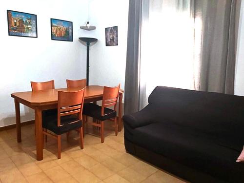 a living room with a table and chairs and a couch at Arcadia Centro de Andalucía in Encinas Reales
