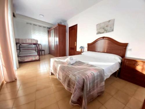 a bedroom with a large bed and a chair at Arcadia Centro de Andalucía in Encinas Reales