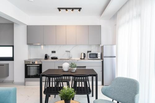 a kitchen with a table and chairs in a room at Emerald Island Residential Complex in Skala Rachoniou