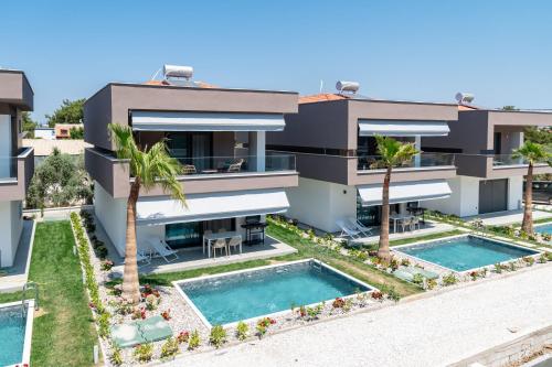an aerial view of a villa with two swimming pools at Emerald Island Residential Complex in Skala Rachoniou