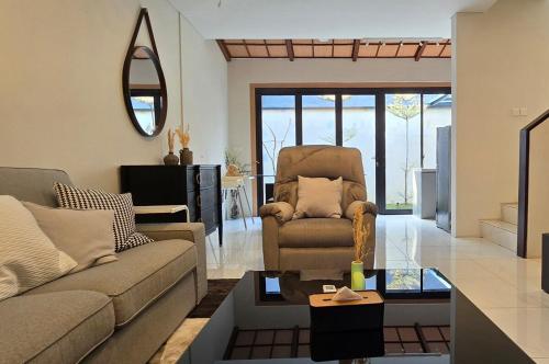 a living room with a couch and a chair at Arumnala with butler and Breakfast at KBP in Gantungan