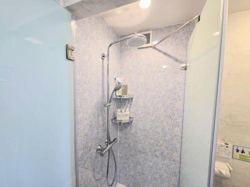 a shower in a bathroom with a glass door at Backshore 99 in Kujukuri
