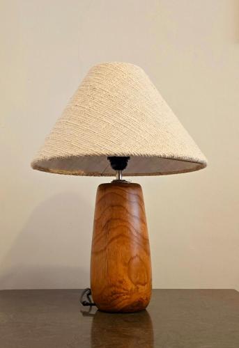a lamp with a hat on top of a table at Arumnala with butler and Breakfast at KBP in Gantungan