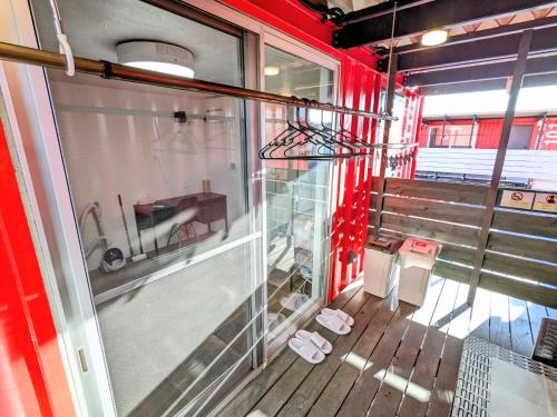 a room with a window and a bench on a train at Backshore 99 in Kujukuri