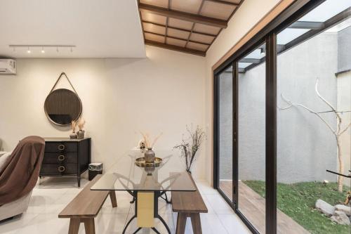 a living room with a glass table and a couch at Arumnala with butler and Breakfast at KBP in Gantungan