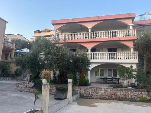 a large building with a balcony on top of it at Studio Sea View Steps to Przno beach w Parking Villa Olive in Pržno
