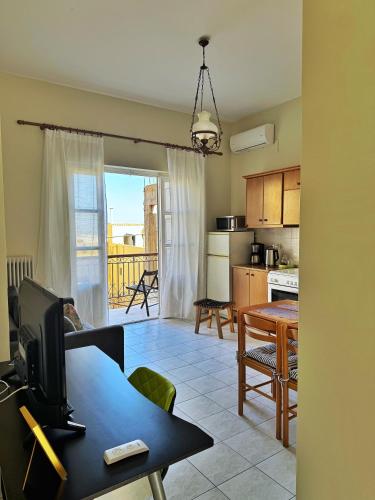 a living room with a table and a kitchen at Prince of Aegean - Two Balconies in Ermoupoli