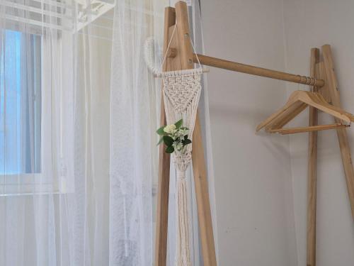 a wedding dress on a hanger with a flower on it at Eumm stay in Cheongju