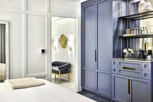 a bedroom with a purple cabinet and a chair at The Ritz-Carlton, Half Moon Bay in Half Moon Bay