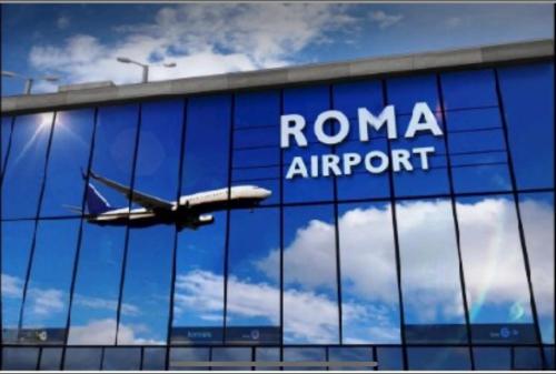 an airplane reflecting in the windows of a roma airport at Suite Moderna 60 m2 con terrazzo privato - 5 min da Aeroporto FCO e Fiera di Roma in Fiumicino Airport