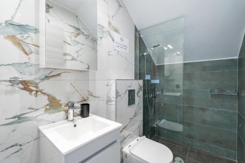 a bathroom with a sink and a toilet and a shower at Emerald Island Residential Complex in Skala Rachoniou